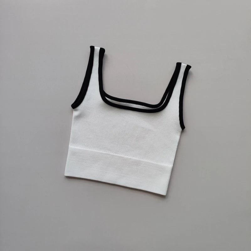 Ladies seamless yoga vest in white with black trim, perfect for workouts and casual wear