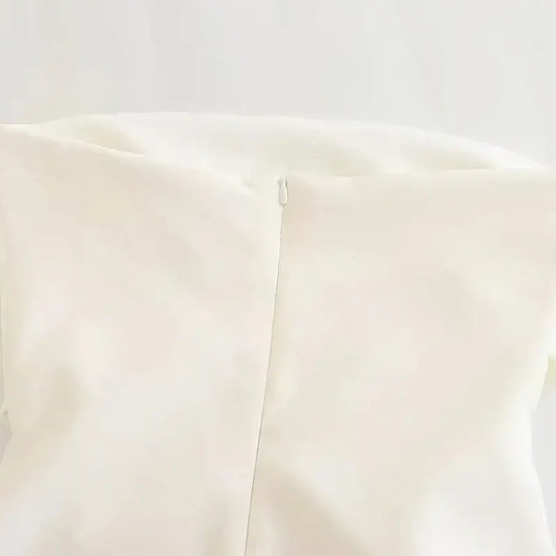 Close-up of white strapless corset top with zipper detail from The Lady's Haven Boutique