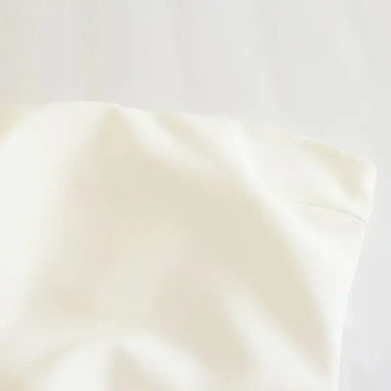 Close-up of white smooth fabric of a strapless corset top from The Lady's Haven Boutique