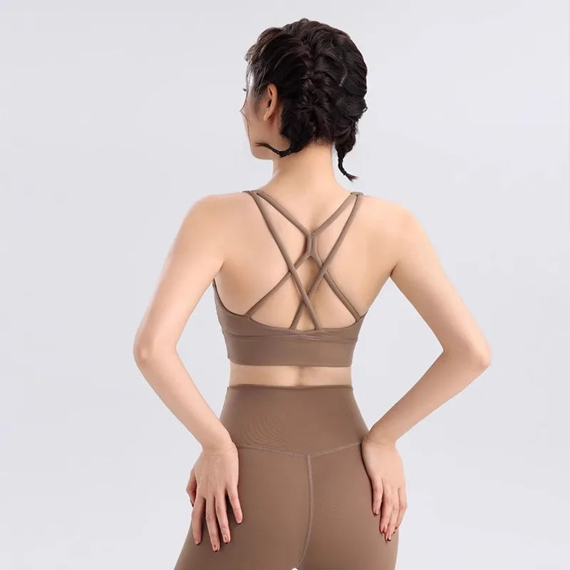 Stylish ladies two piece gym suit in brown with crisscross strap design for active workouts