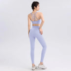 Stylish ladies two piece gym suit in soft lavender with crisscross back detailing