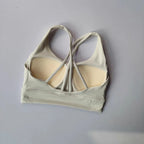 Ladies two piece gym suit featuring a stylish back design and supportive sports bra in light gray