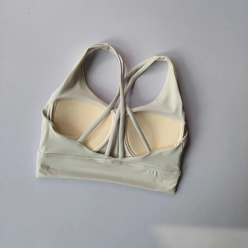 Ladies two piece gym suit featuring a stylish back design and supportive sports bra in light gray