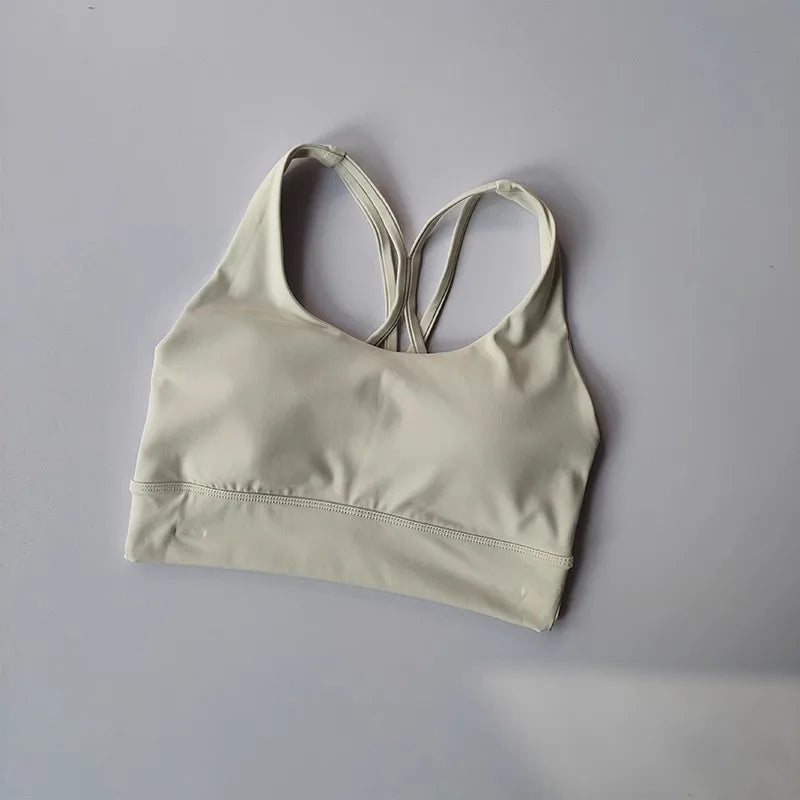 Ladies two piece gym suit featuring a stylish sports bra with crisscross straps