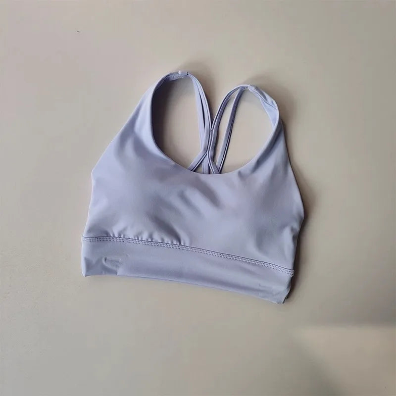 Ladies two piece gym suit top in light purple with racerback design for active workouts