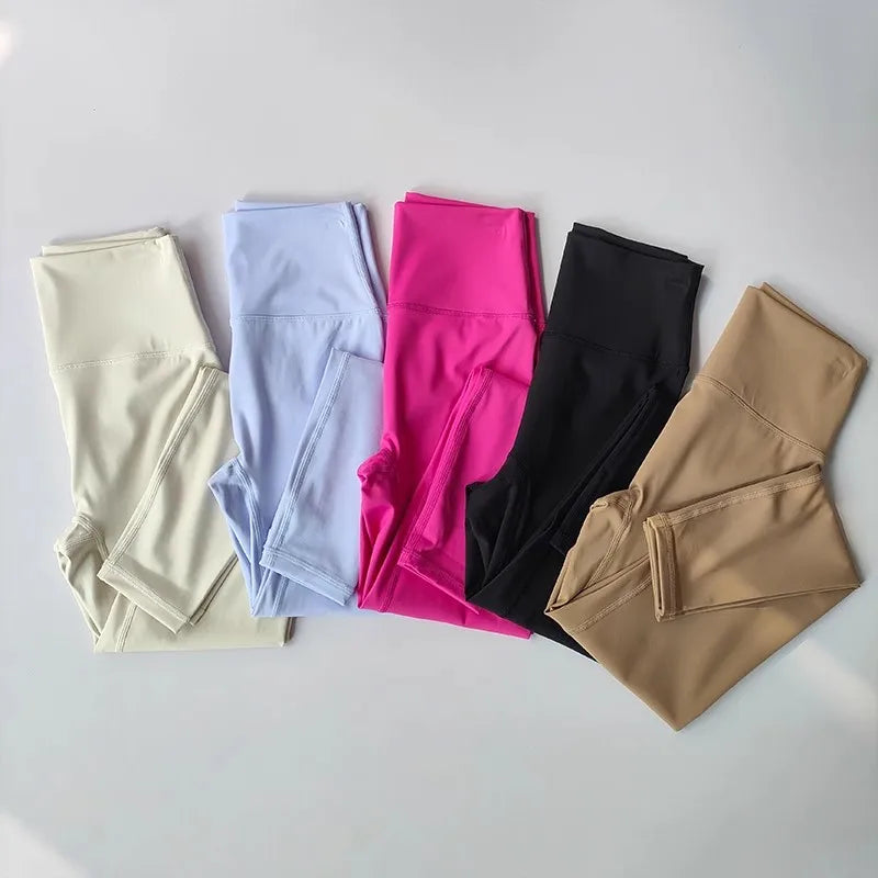 Variety of ladies two piece gym suits in colors including black, pink, blue, beige, and cream