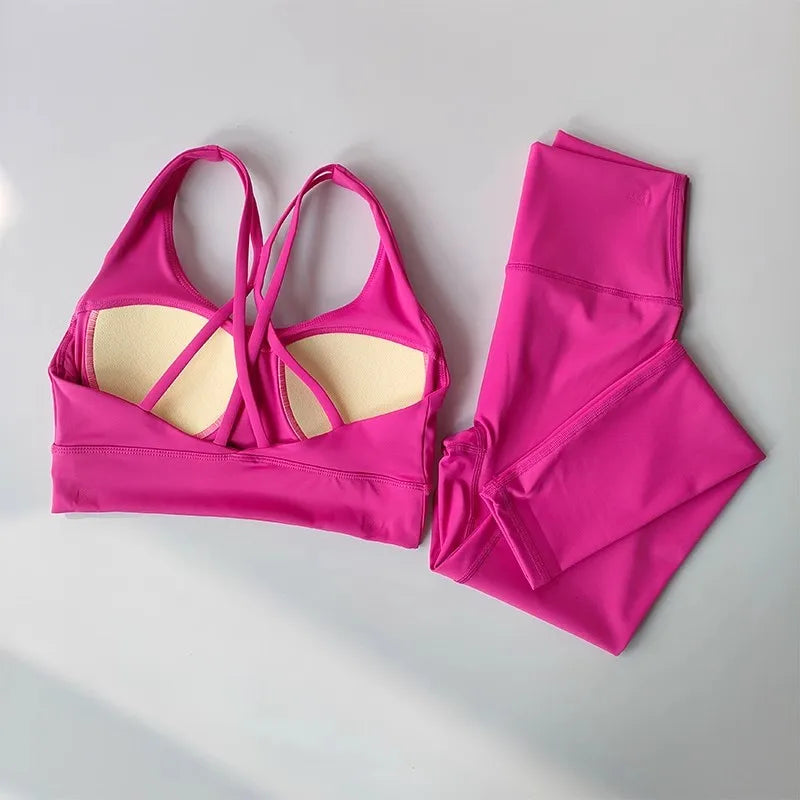 Ladies two piece gym suit in vibrant pink with a stylish crisscross back design and matching leggings