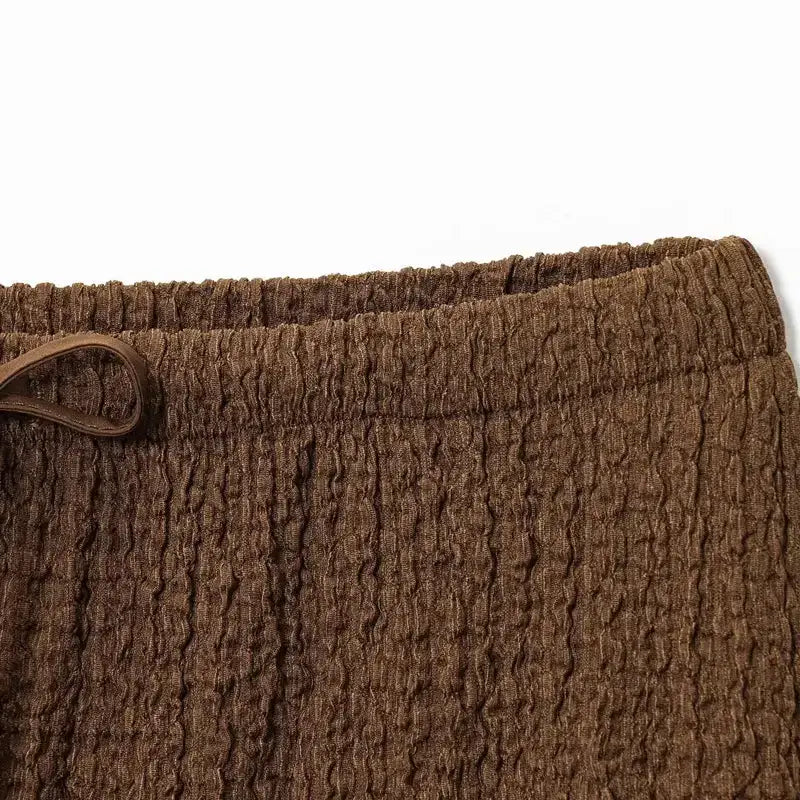 Close-up of brown textured fabric waistband detail from The Lady's Haven Boutique two piece wide leg pant set