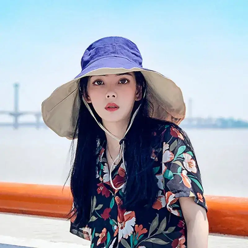 Stylish women's UPF 50 sun protection hat in blue and beige for outdoor activities