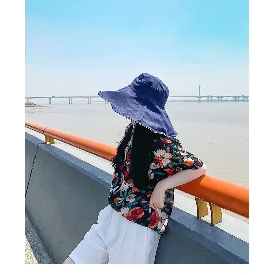Floral print hat perfect for outdoor wear with UPF 50 sun protection hat featured against a scenic backdrop