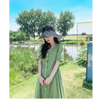 Stylish green dress paired with a wide-brimmed UPF 50 sun protection hat by The Lady's Haven Boutique
