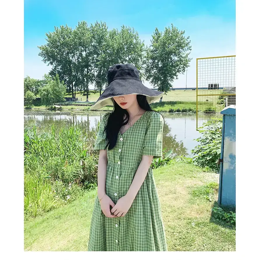 Stylish green dress paired with a wide-brimmed UPF 50 sun protection hat by The Lady's Haven Boutique