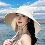 Model wearing a ladies UV sun protection bucket hat by The Lady's Haven Boutique at the beach