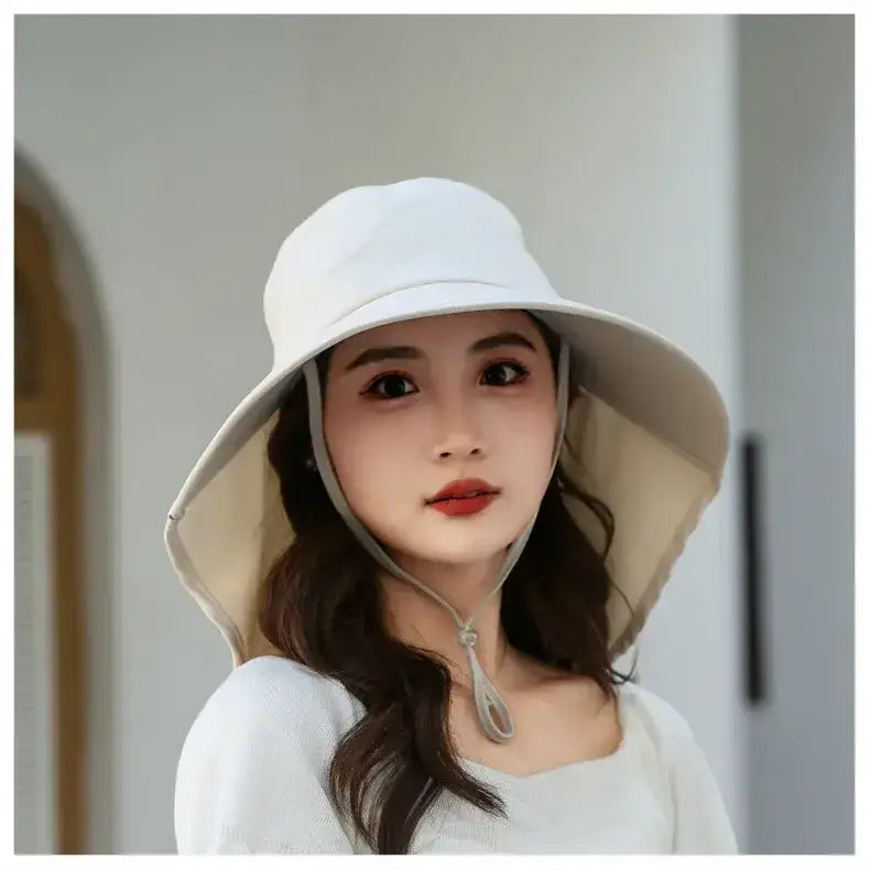 Ladies UV sun protection bucket hat in light beige with wide brim and adjustable chin strap