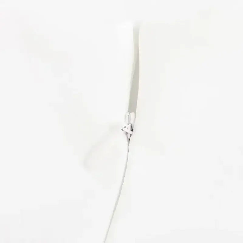 Close-up of zipper detail on white summer party mini dress from The Lady's Haven Boutique