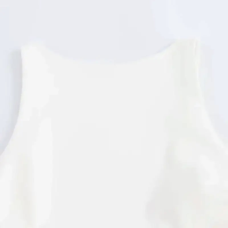 Close-up of a white summer party mini dress sleeveless top from The Lady's Haven Boutique