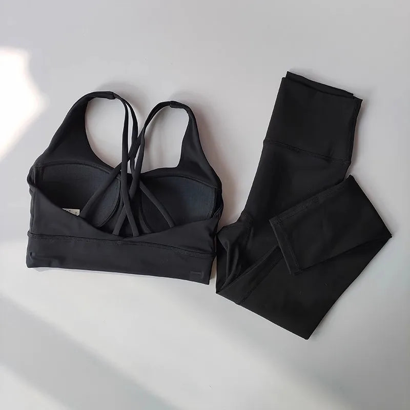 Black ladies workout clothes set featuring a stylish sports bra and high-waisted leggings