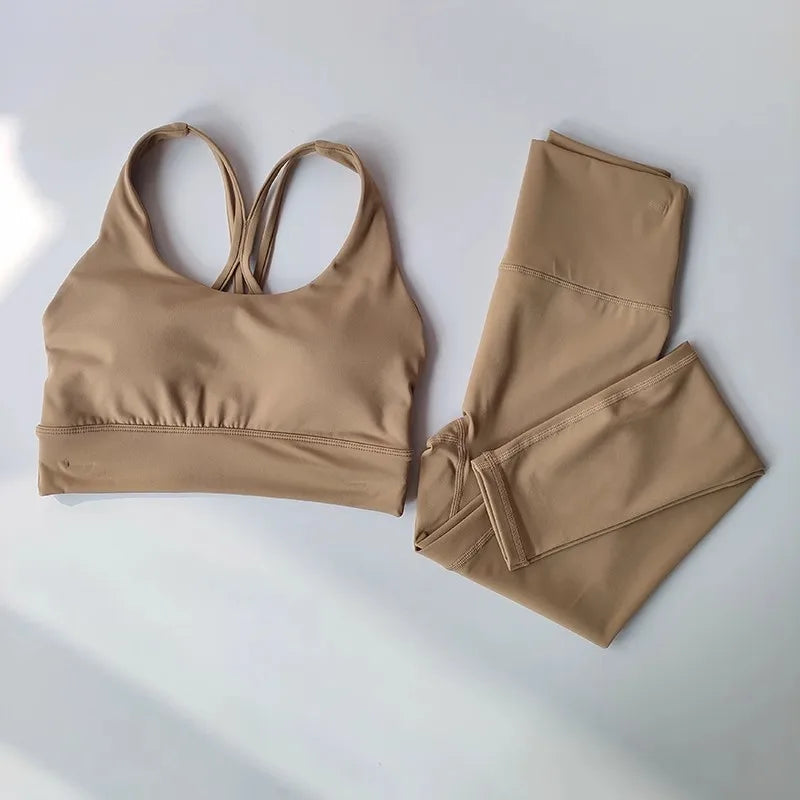 Stylish ladies workout clothes set in beige featuring a stylish sports bra and matching leggings