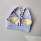 Soft lavender ladies workout clothes set featuring a stylish strappy sports bra with light padding