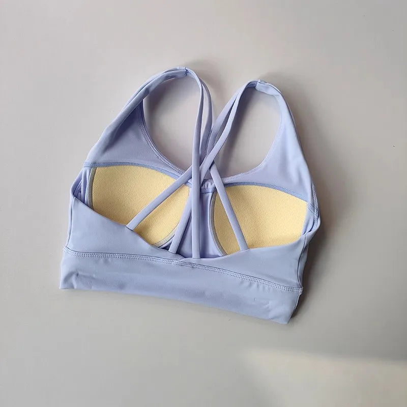 Soft lavender ladies workout clothes set featuring a stylish strappy sports bra with light padding