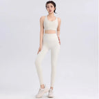 Elegant ladies workout clothes set in cream with a stylish crop top and high-waisted leggings