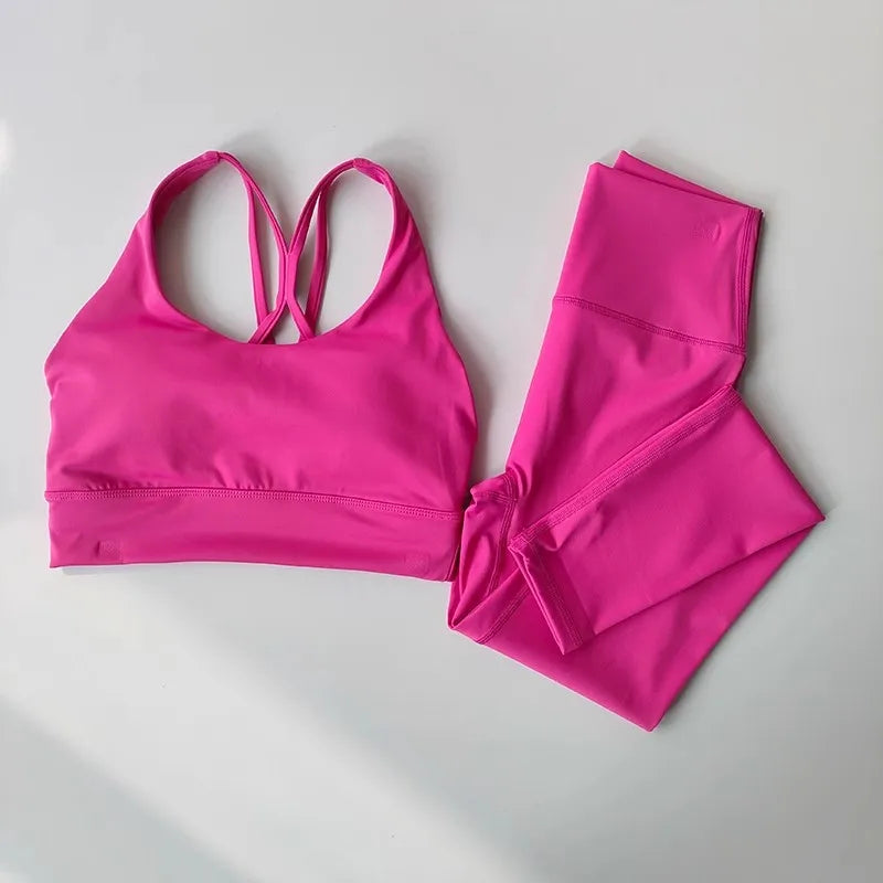 Bright pink ladies workout clothes set featuring a stylish sports bra and matching leggings