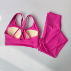 Bright pink ladies workout clothes set including a strappy top and leggings