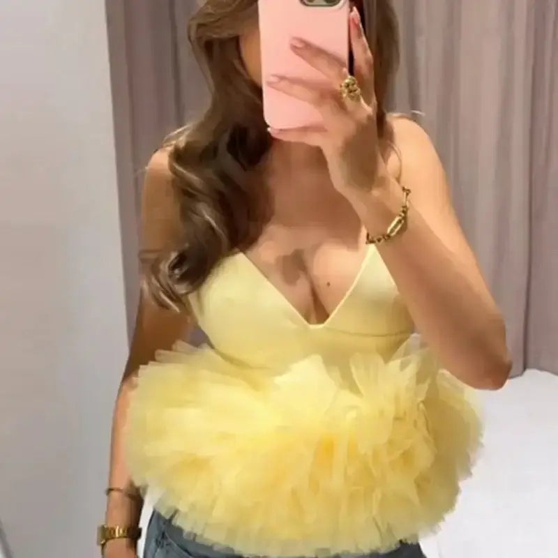 Yellow puffy sleeveless summer top with layered tulle design worn by woman taking mirror selfie