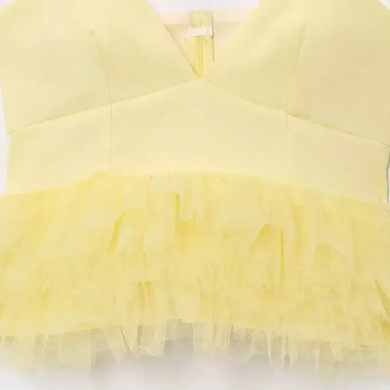 Yellow puffy sleeveless summer top with layered tulle design from The Lady's Haven Boutique