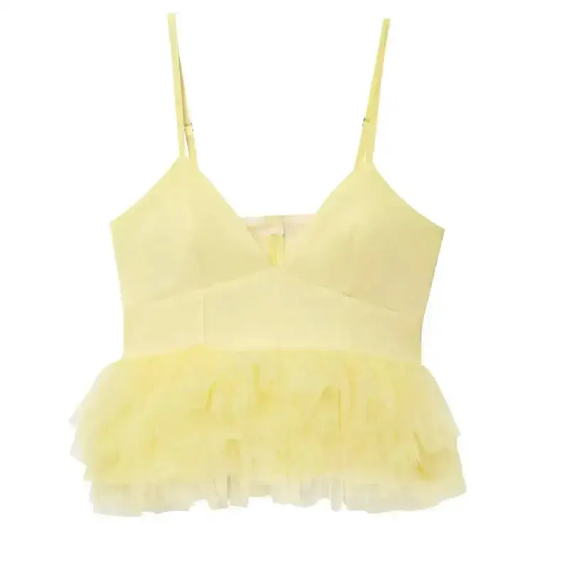 Light yellow puffy sleeveless summer top with thin straps and layered ruffle hem