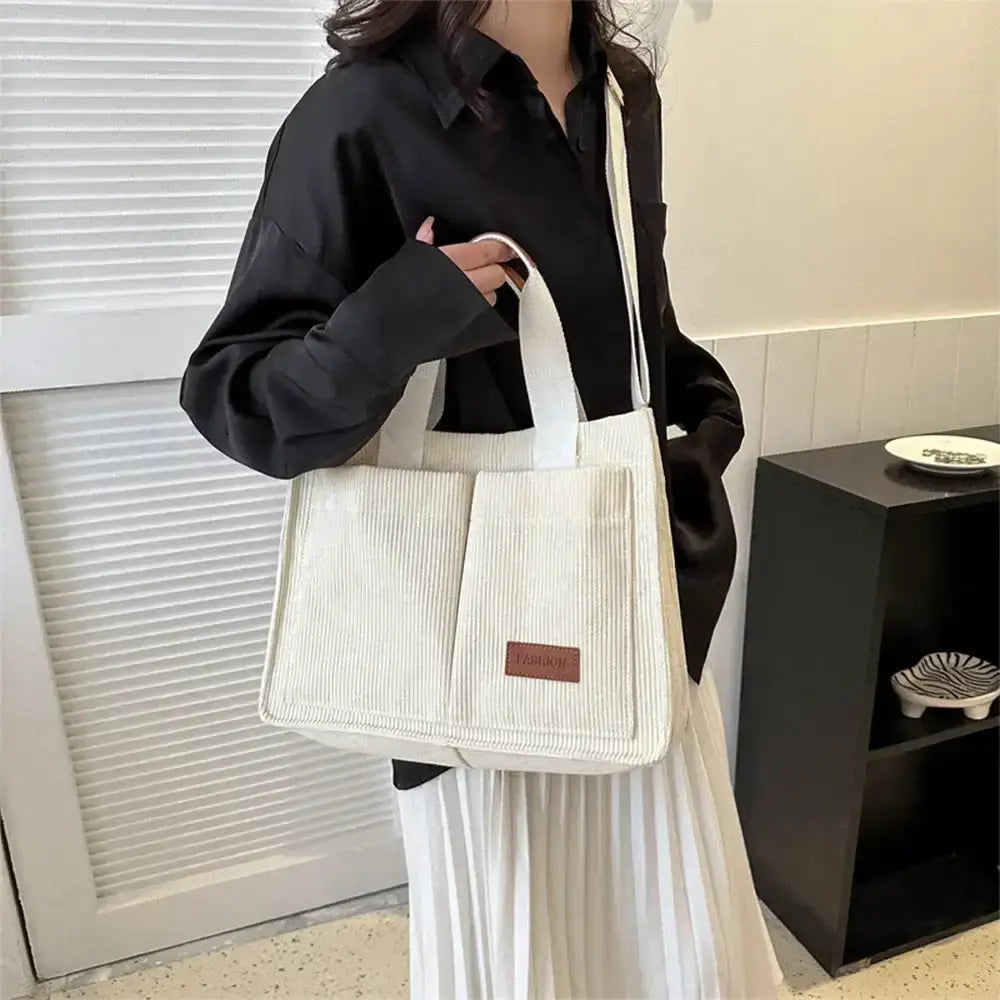 Stylish cream large capacity handbag with comfortable shoulder straps and multiple pockets for everyday use