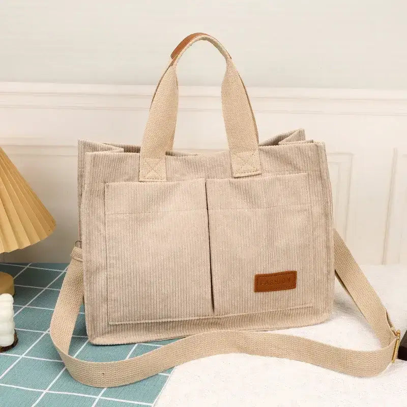 Beige large capacity handbag with multiple pockets for organized storage and a stylish design