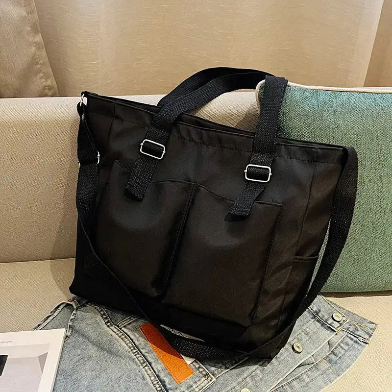 Stylish black large capacity shopper handbag with multiple pockets for versatile use