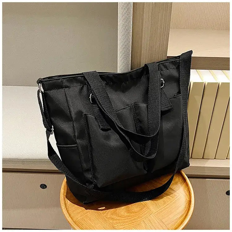 Stylish large capacity shopper handbag in black with multiple pockets for everyday use