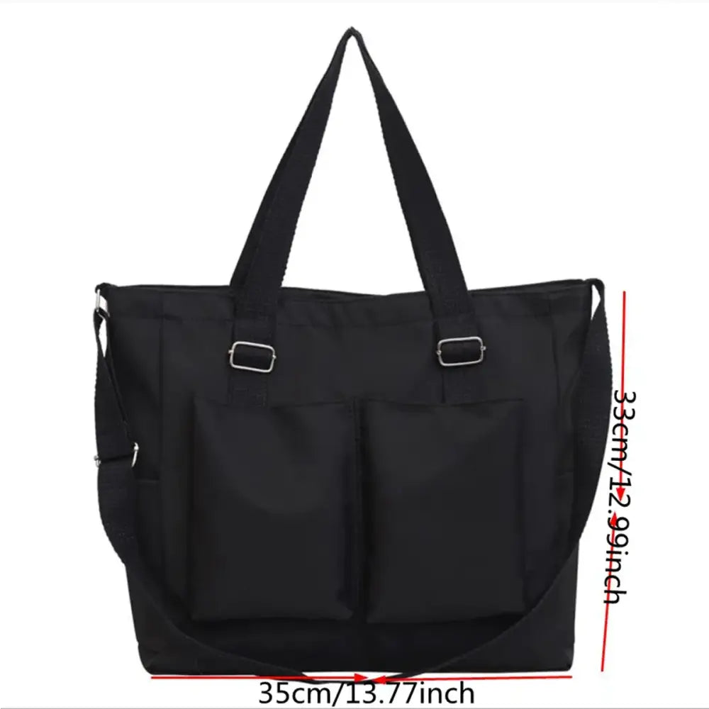 Stylish black large capacity shopper handbag with front pockets and adjustable straps for everyday use
