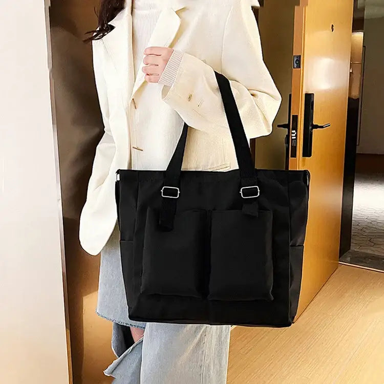 Stylish black large capacity shopper handbag with two front pockets for everyday use