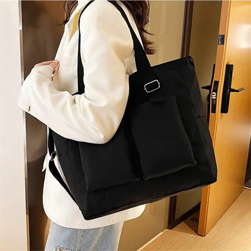 Stylish black large capacity shopper handbag with multiple pockets for everyday use