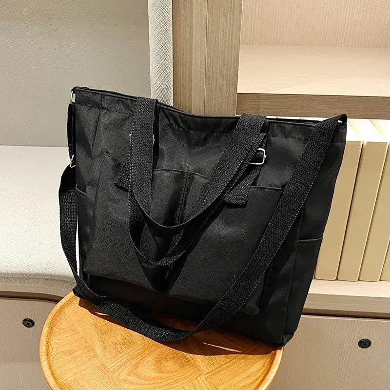 Black large capacity shopper handbag with sturdy straps for daily use and stylish storage