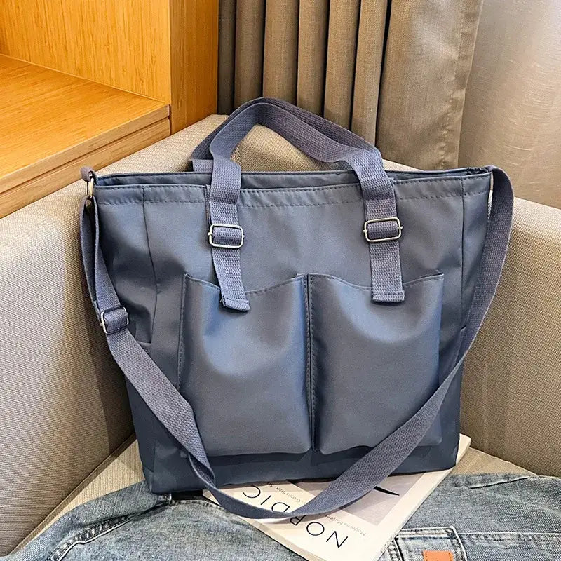 Stylish large capacity shopper handbag in blue with multiple pockets for convenient storage