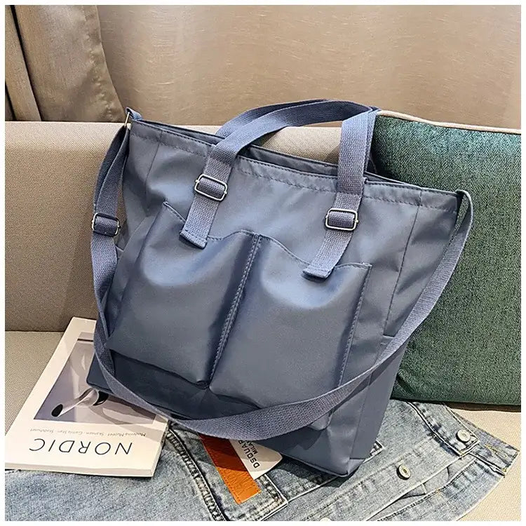 Durable large capacity shopper handbag with multiple exterior pockets in stylish gray design