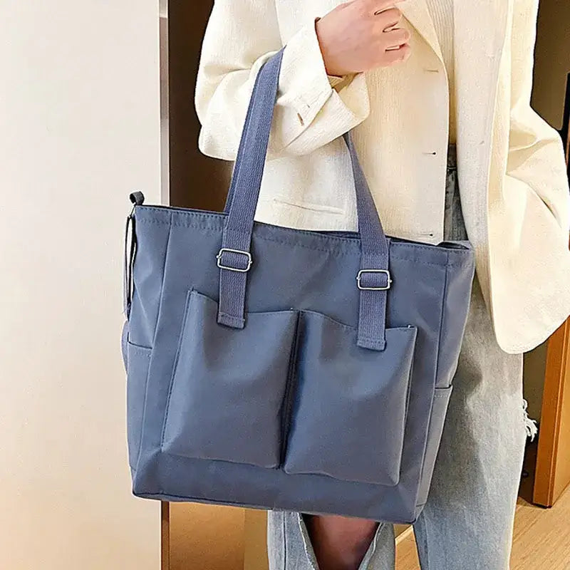 Stylish large capacity shopper handbag in navy blue with front pockets for easy organization