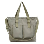 Large capacity shopper handbag in beige with exterior pockets and adjustable straps