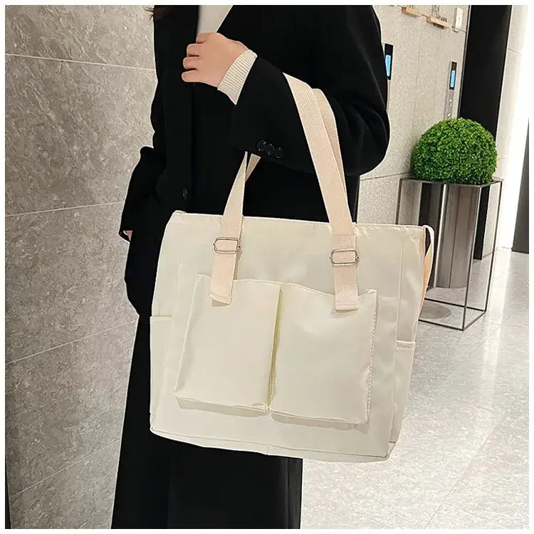 Stylish large capacity shopper handbag in cream with two front pockets for everyday use