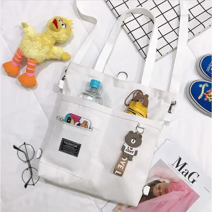 Large capacity tote bag for women in white with cute cartoon patches and multiple pockets