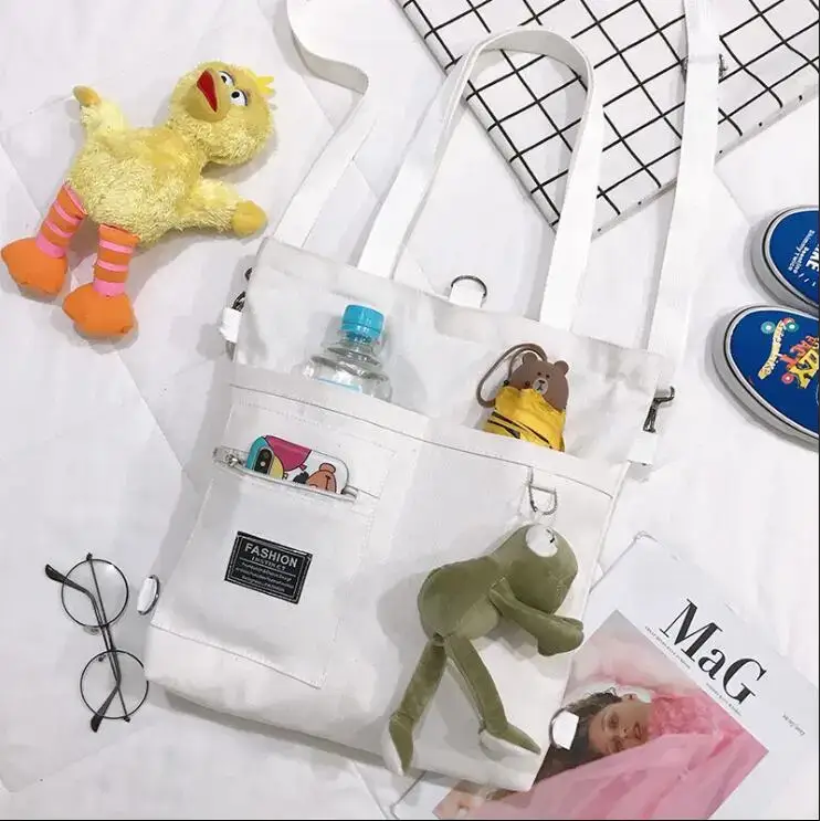 Large capacity tote bag for women in white with multiple pockets and playful accessories