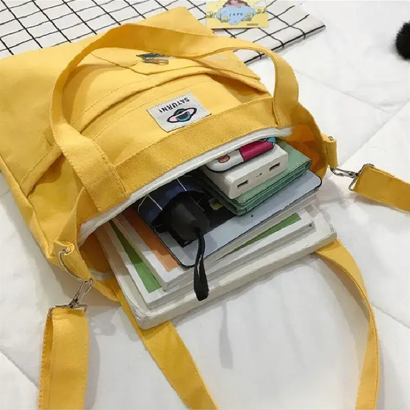 Yellow large capacity tote bag for women filled with books and essentials for daily use