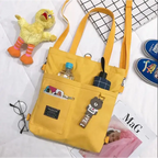 Bright yellow large capacity tote bag for women with multiple pockets and cute accessories