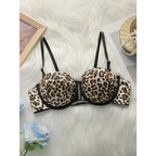 Leopard print push up bra with black straps and underwire support laid on white fur background