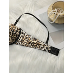 Leopard print push up bra with adjustable black straps laid on white fur next to pearl necklace