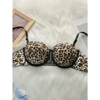 Leopard print push up bra with black trim laid on white faux fur background from The Lady's Haven Boutique